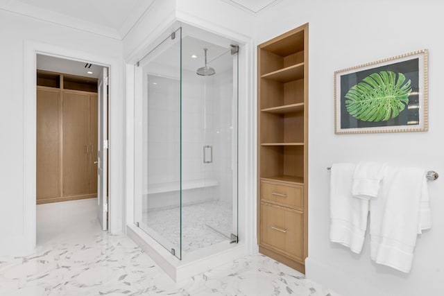 bathroom with ornamental molding, built in shelves, and an enclosed shower