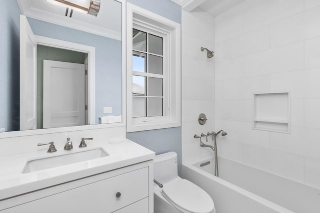 full bathroom featuring tiled shower / bath, vanity, ornamental molding, and toilet