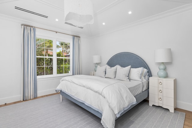 bedroom featuring crown molding and hardwood / wood-style floors