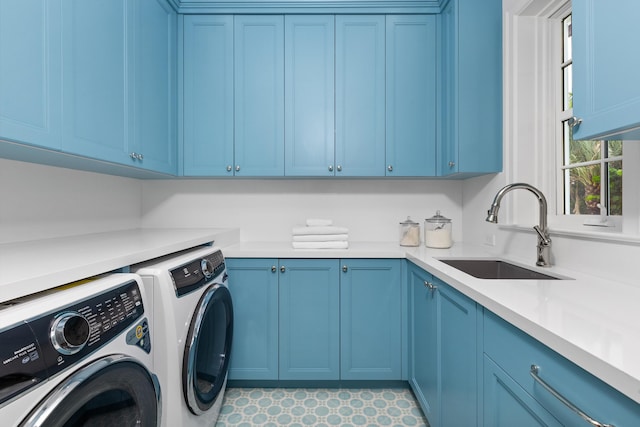 washroom featuring cabinets, washer and dryer, and sink