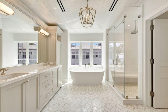 bathroom with a shower stall, wooden ceiling, a freestanding tub, a chandelier, and double vanity