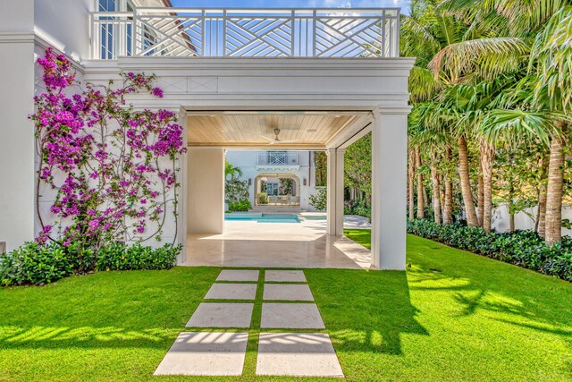 view of property's community with a swimming pool, a yard, and a patio