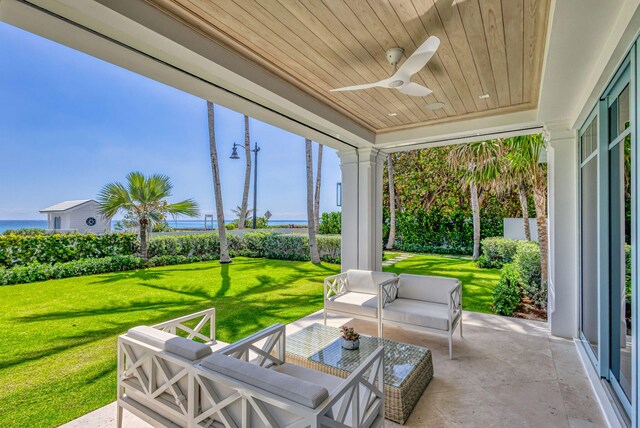 view of patio with an outdoor living space, a ceiling fan, and a water view