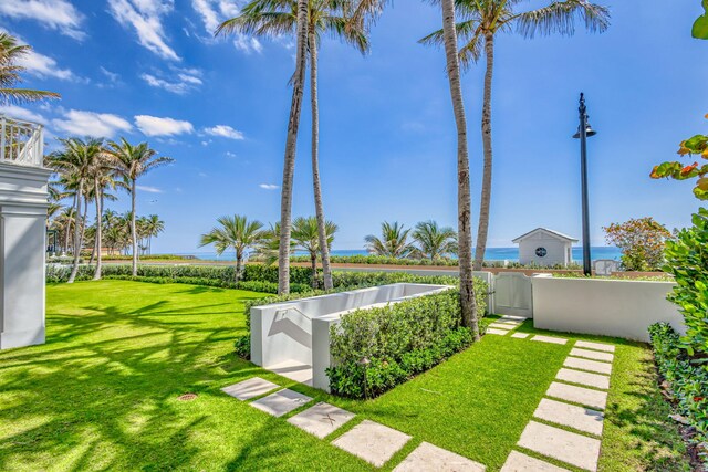 view of yard with a water view and a gate