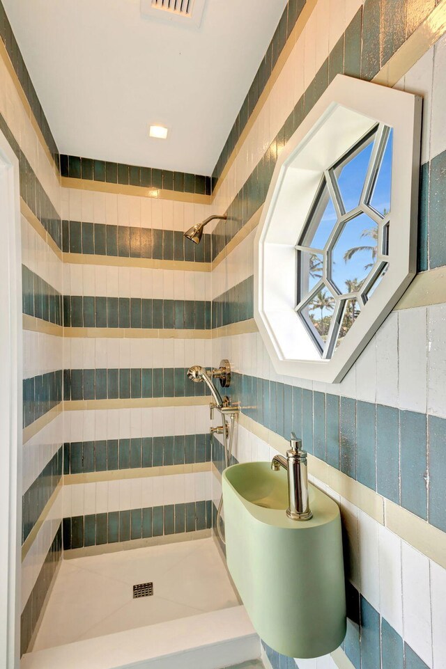 bathroom with a tile shower