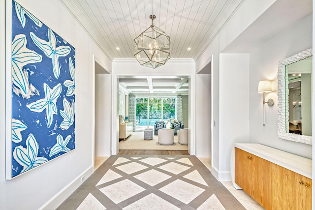 hallway with ornamental molding, coffered ceiling, a chandelier, baseboards, and recessed lighting