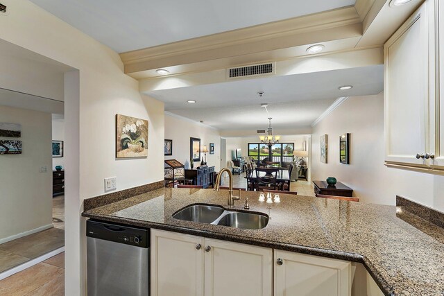 kitchen featuring stainless steel dishwasher, a chandelier, dark stone counters, ornamental molding, and sink