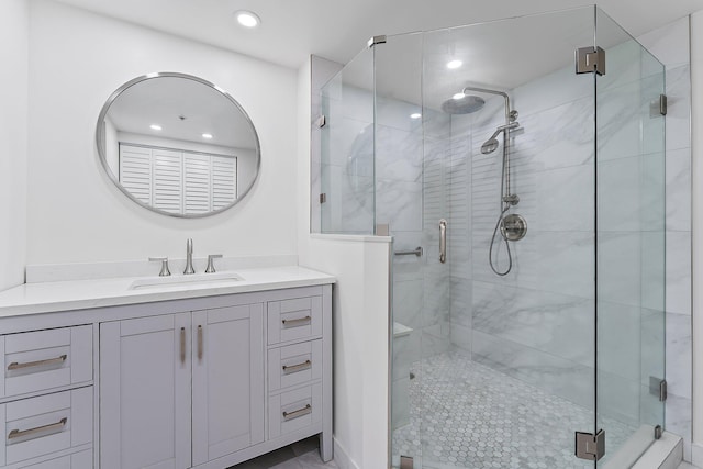 bathroom featuring vanity and a shower with shower door