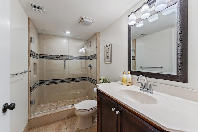 bathroom with vanity, toilet, walk in shower, and tile patterned flooring