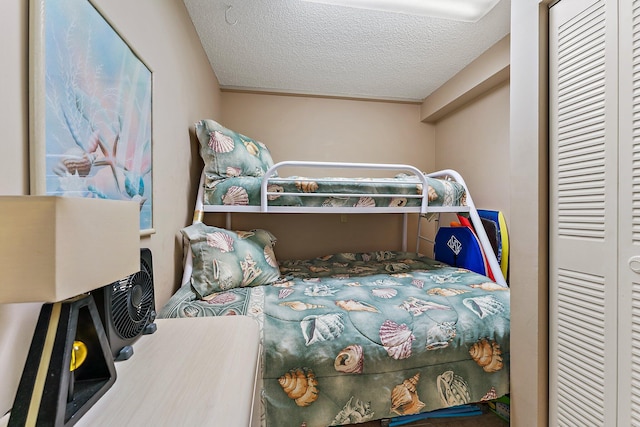 bedroom with a closet and a textured ceiling