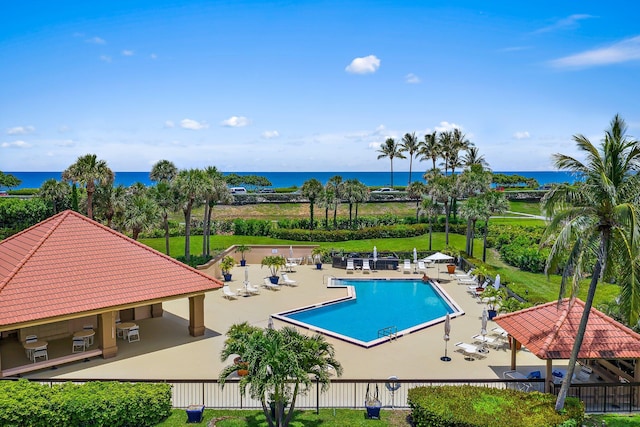 view of pool with a patio, a gazebo, and a water view