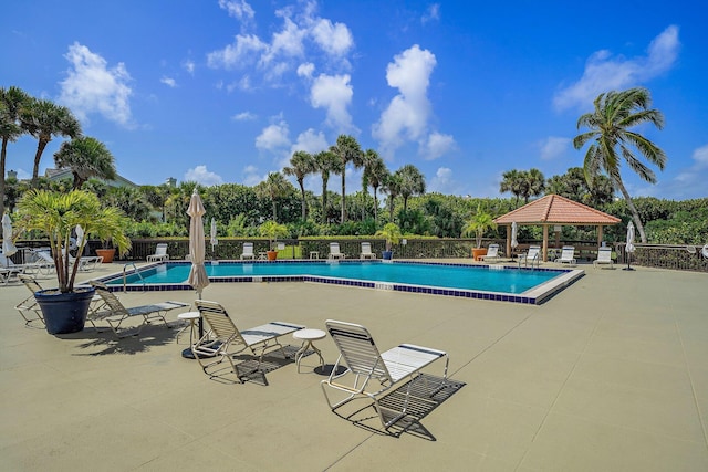 view of swimming pool with a patio and a gazebo