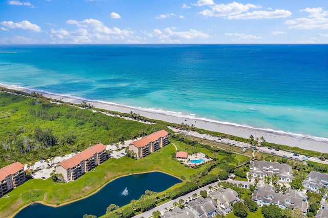 drone / aerial view featuring a water view and a beach view