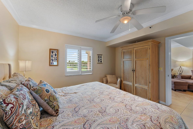 tiled bedroom featuring ceiling fan, a textured ceiling, and ornamental molding