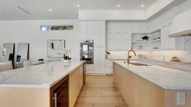 kitchen featuring a spacious island and white cabinetry