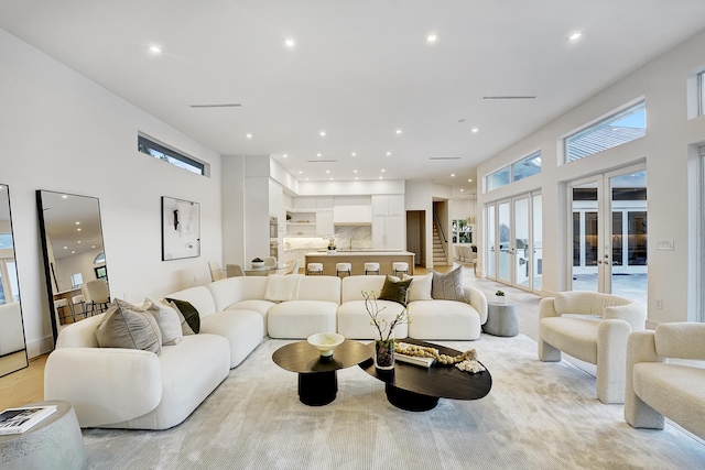 living room featuring french doors and light hardwood / wood-style flooring