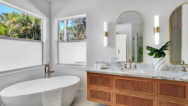 bathroom with vanity, shower with separate bathtub, and tile patterned floors