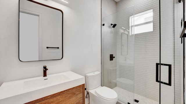 bathroom with toilet, a shower with shower door, and vanity