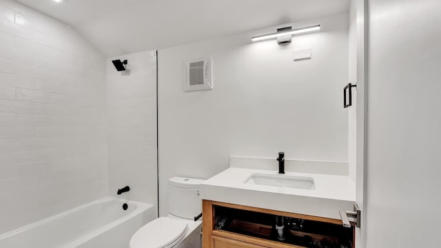 full bathroom with vanity, tiled shower / bath, toilet, and vaulted ceiling