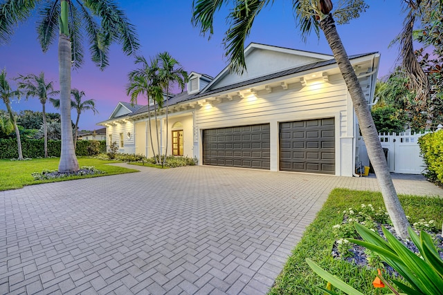 view of front of property with a lawn and a garage