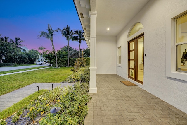 patio terrace at dusk with a lawn