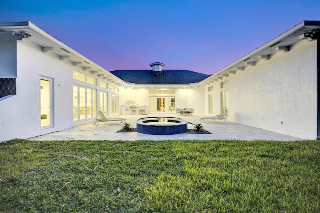 yard at dusk with a patio and a fire pit