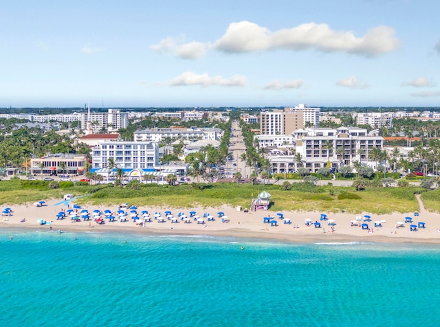 drone / aerial view with a water view and a view of the beach