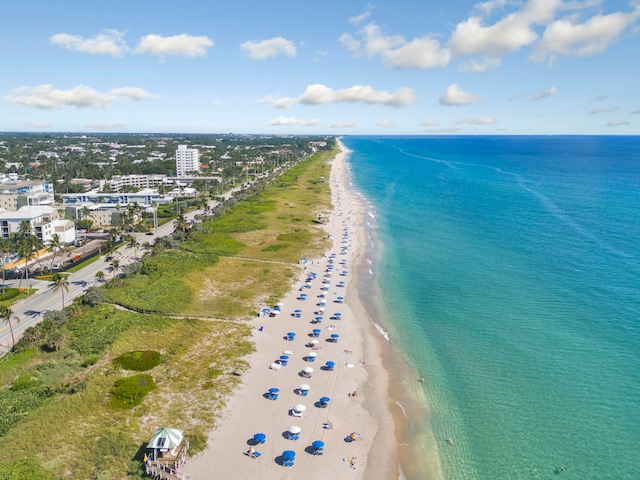 bird's eye view featuring a view of the beach and a water view