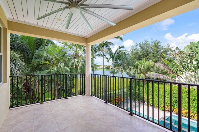 balcony featuring a water view and ceiling fan