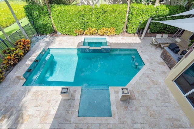 view of swimming pool featuring an in ground hot tub and a patio