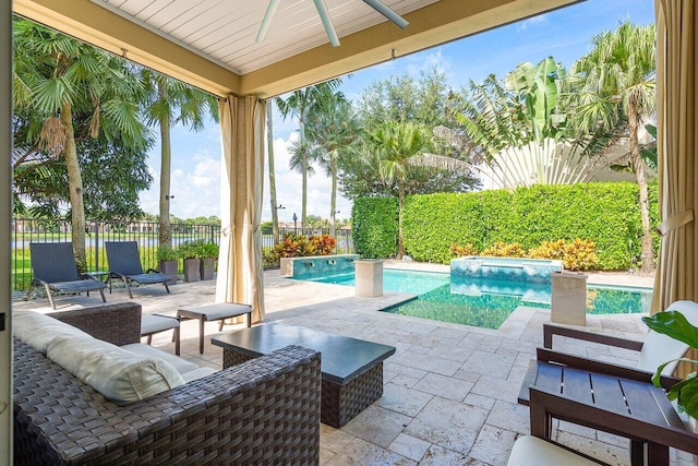 view of patio / terrace with a fenced in pool and ceiling fan