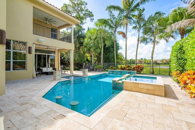 view of swimming pool with an in ground hot tub, an outdoor living space, a patio, and ceiling fan