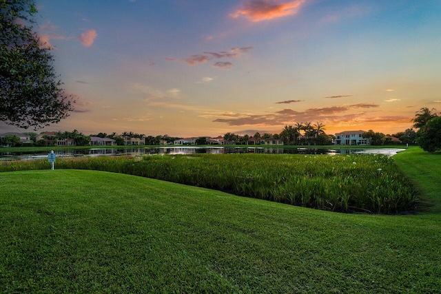 yard at dusk with a water view