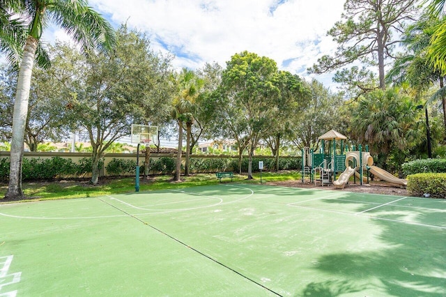 view of sport court featuring basketball court and a playground