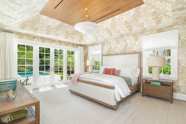 bedroom with french doors, wood ceiling, access to exterior, and carpet