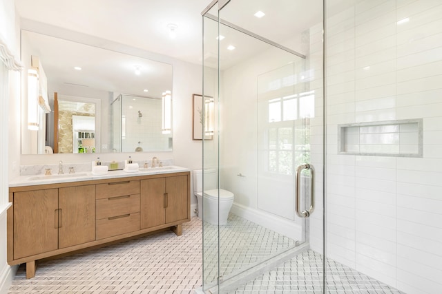 bathroom with vanity, tile patterned flooring, toilet, and walk in shower