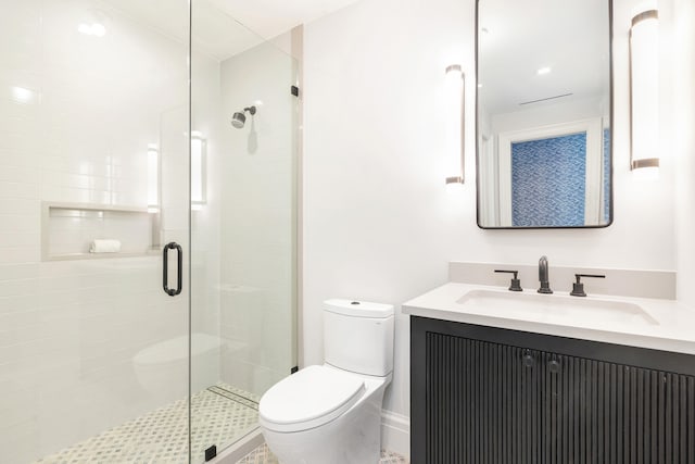 bathroom with toilet, an enclosed shower, and vanity