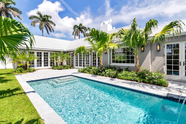 view of swimming pool featuring a patio area and french doors