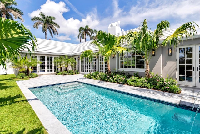 284 Monterey Rd, Palm Beach, FL 33480 - swimming pool featuring french doors, a patio area, and a yard