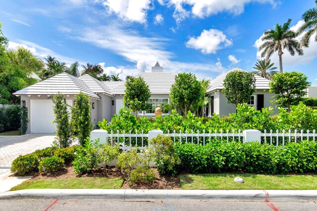 284 Monterey Rd, Palm Beach, FL 33480 - view of front of home with a garage, stucco siding, and driveway