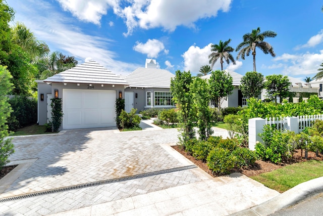 284 Monterey Rd, Palm Beach, FL 33480 - view of front of property featuring an attached garage, decorative driveway, and stucco siding
