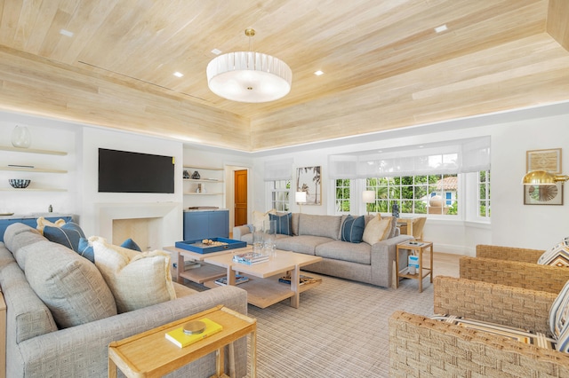 living room with wood ceiling, built in features, and a raised ceiling