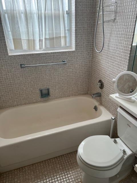 full bathroom featuring vanity, toilet, bathtub / shower combination, and tile patterned flooring