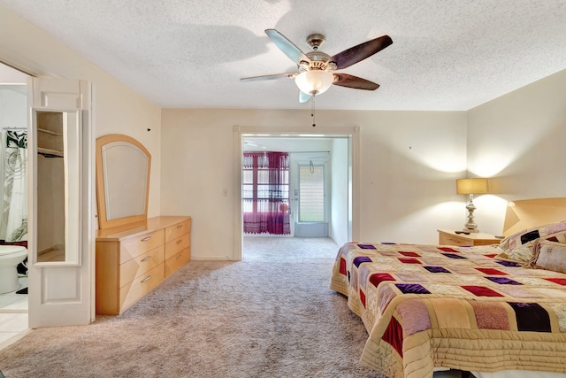 bedroom with a textured ceiling, light colored carpet, and ceiling fan