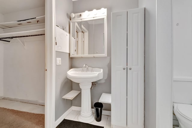 bathroom with tile patterned floors and toilet