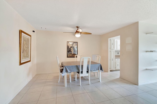 dining space featuring light tile patterned floors, a textured ceiling, and ceiling fan