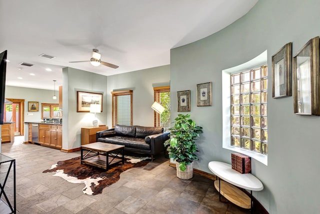 living room featuring sink and ceiling fan