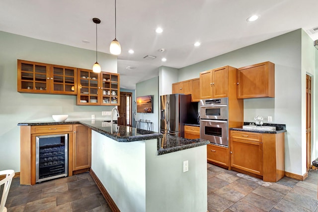 kitchen with kitchen peninsula, stainless steel appliances, dark stone countertops, wine cooler, and decorative light fixtures