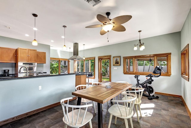 dining space with ceiling fan with notable chandelier