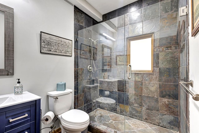 bathroom with a shower with door, vanity, and toilet